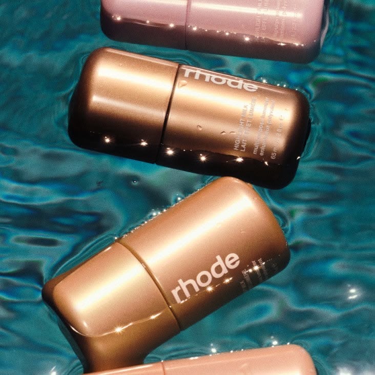 Metallic bottles float between beauty and still life